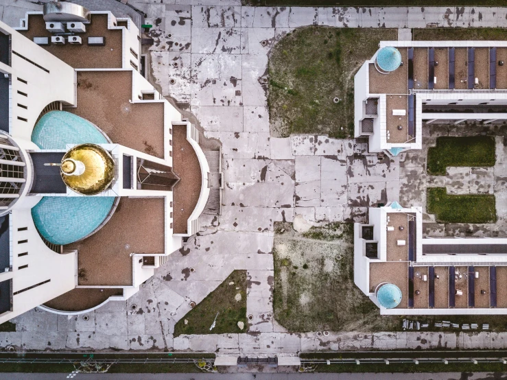 a blue domed clock stands in the center of a courtyard