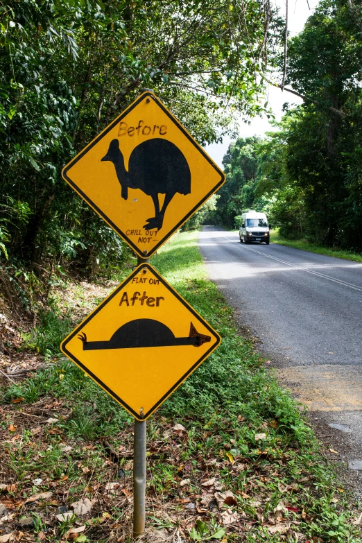 an animal crossing sign stands on the side of a road