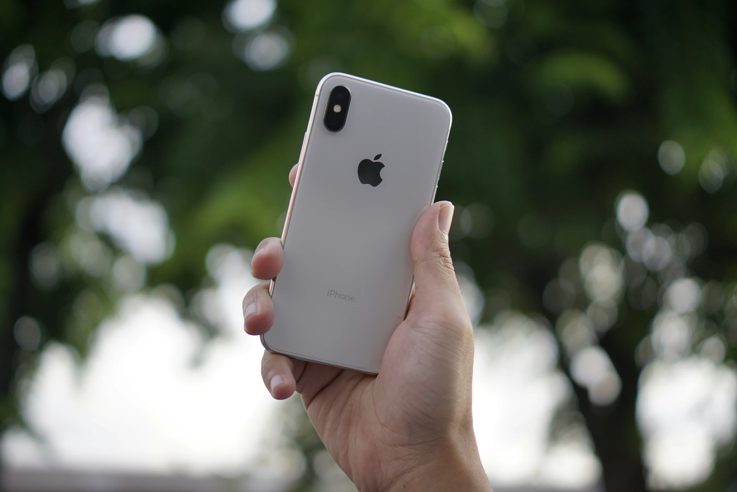 a person is holding up their new iphone