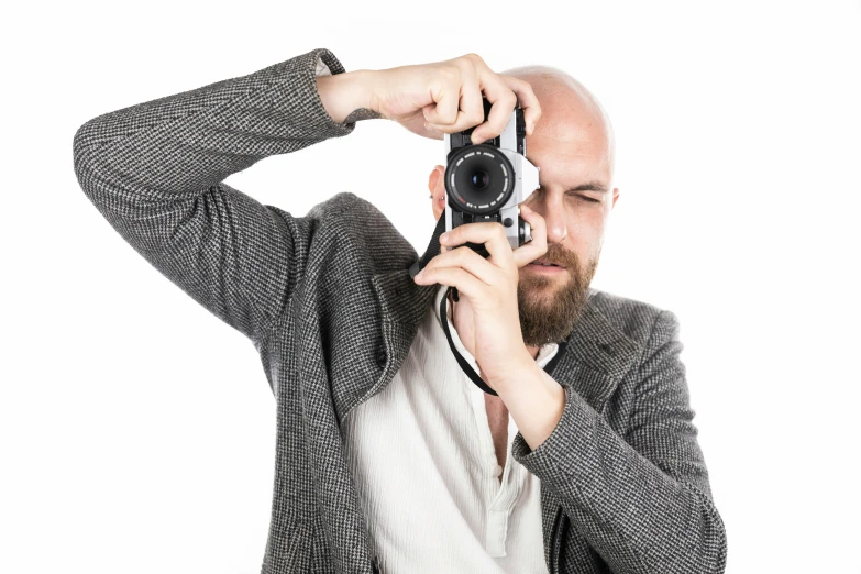 man in grey jacket taking po with camera