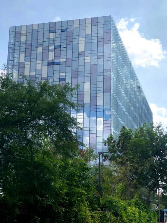 a tall building with the reflection of its windows