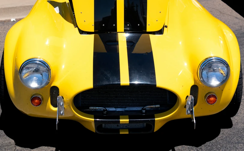 the front grille and hood of a yellow car