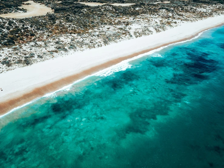 the view of a sandy beach from the air