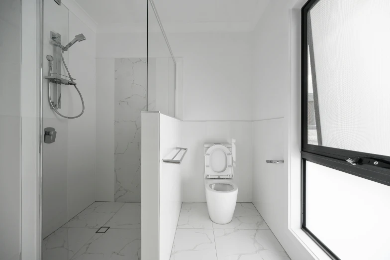 a bathroom with a glass shower door and toilet