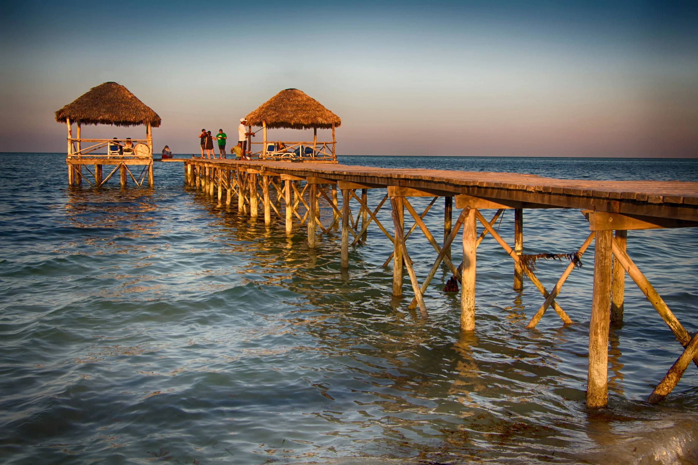 three wooden piers in the middle of a body of water