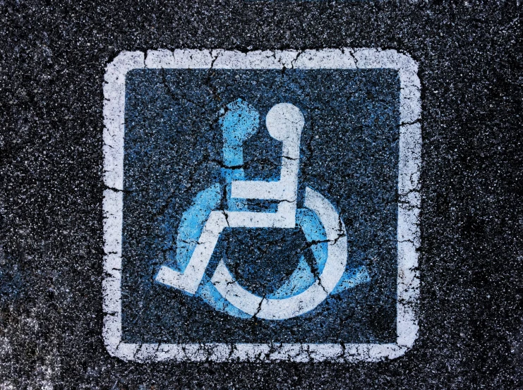 a sign is depicted with the wheelchair symbol