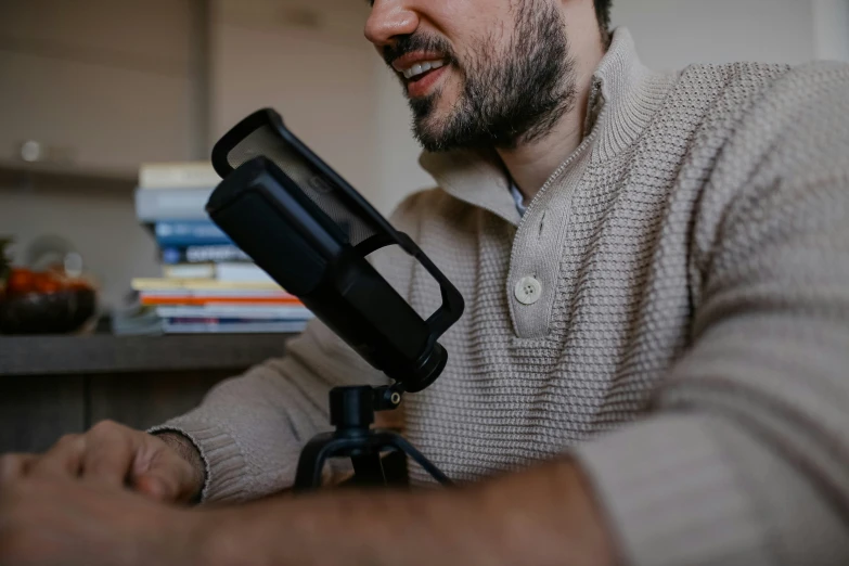 a man holding a camera next to his hand