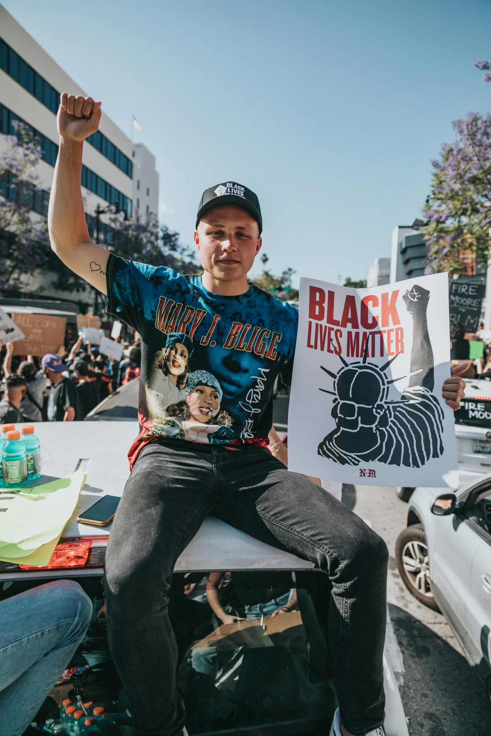 a man is holding up a poster on the street