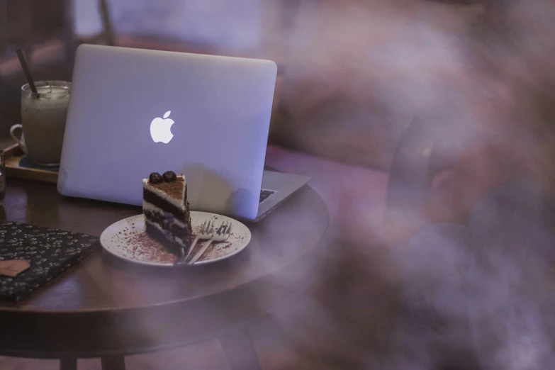 someone is about to use their computer to eat cake