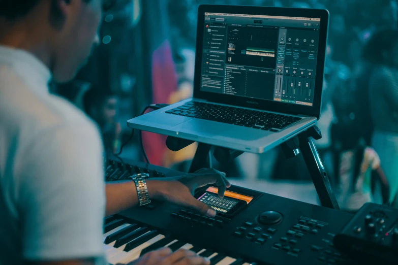 a man sitting at an electronic keyboard