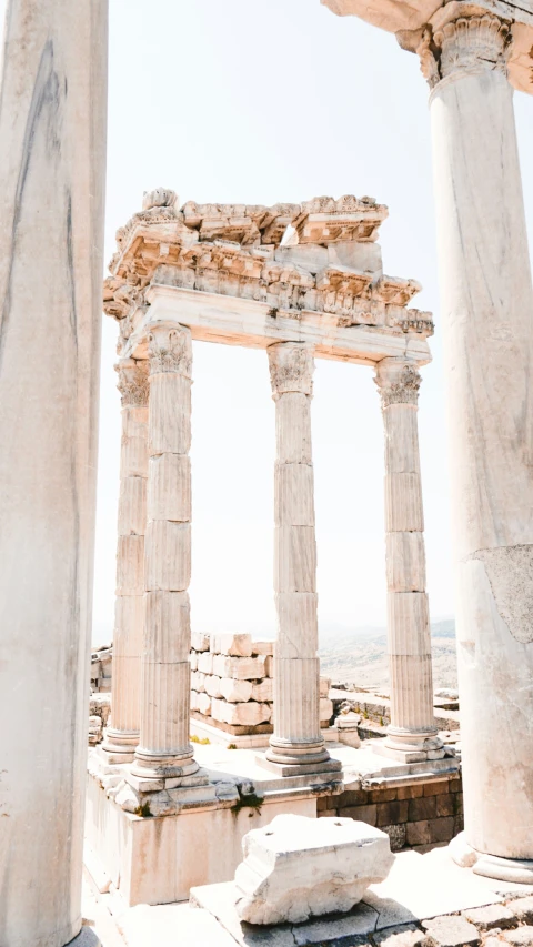 the white building has three large pillars on each side