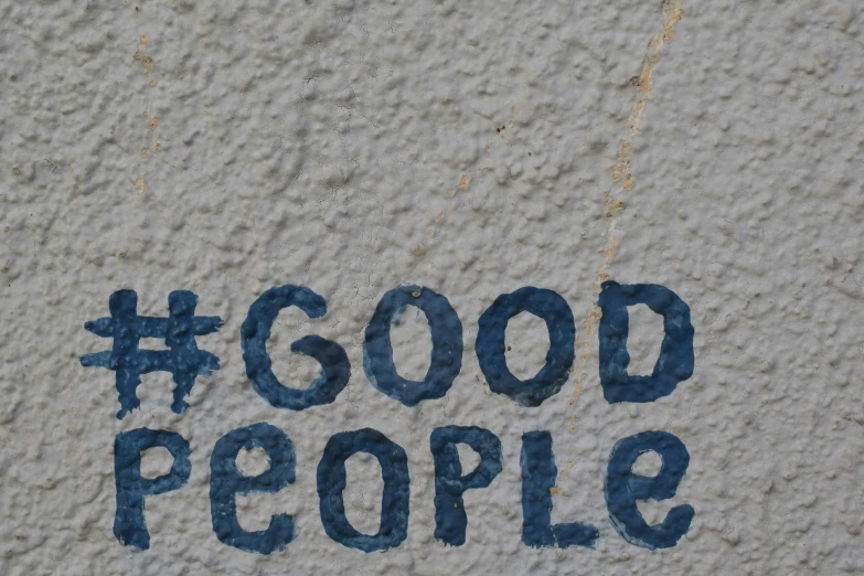a message painted on the cement saying good people