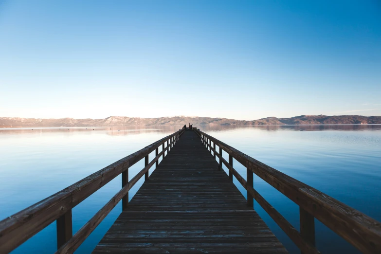 a wooden dock in front of the water