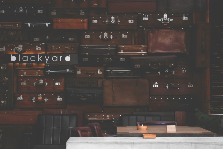 tables and brown leather chairs in front of large wooden crates