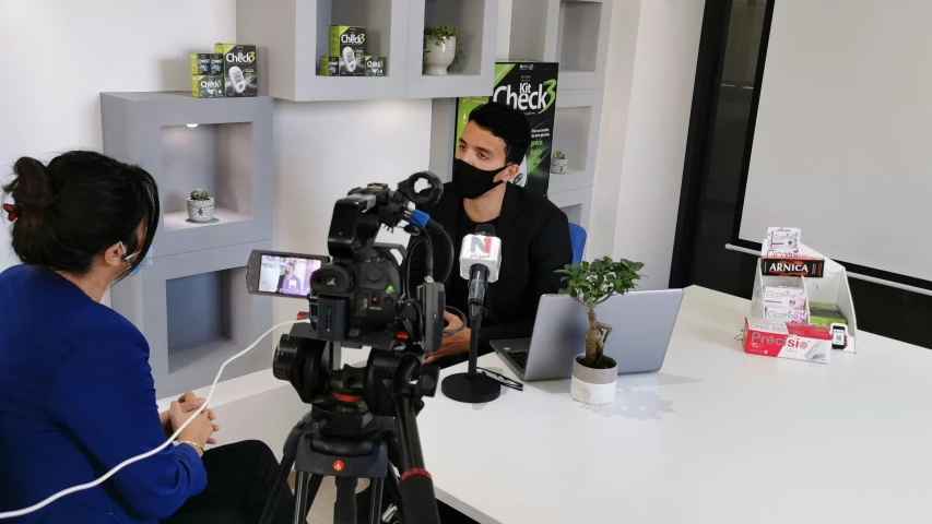 two people at a table with cameras