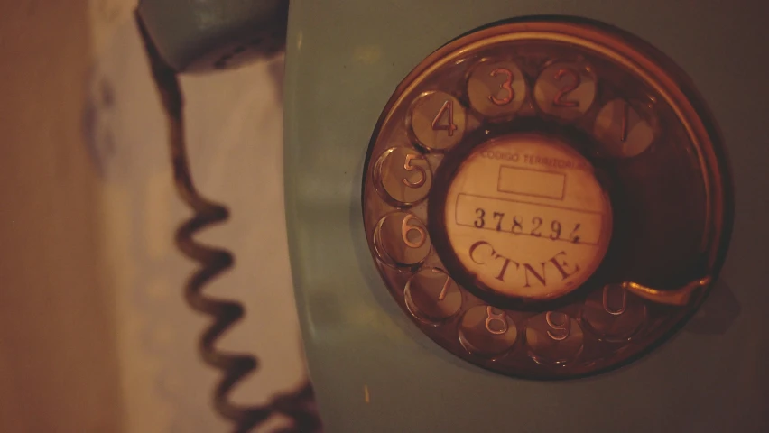 an old rotary phone attached to the wall