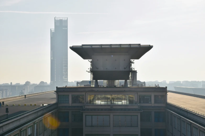 a building that has the sun out and the buildings in the background