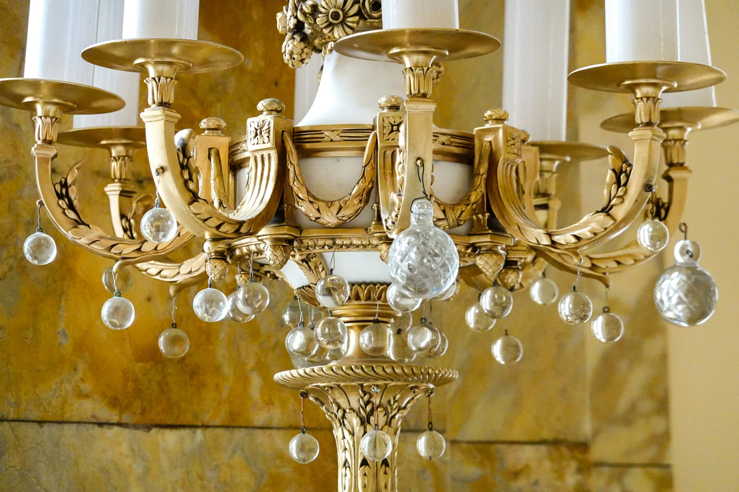a fancy gold chandelier hangs in the corner