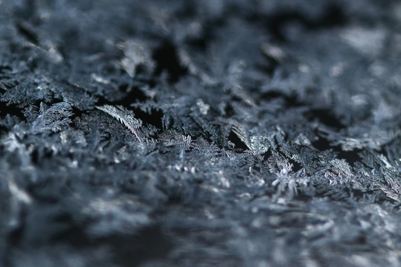 a texture of gray material sitting on top of a blue table