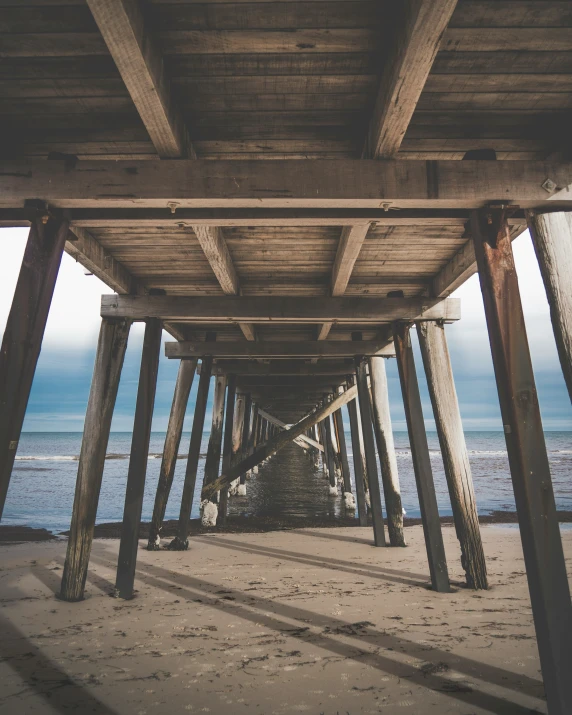 an ocean pier with beams that are bent and suspended