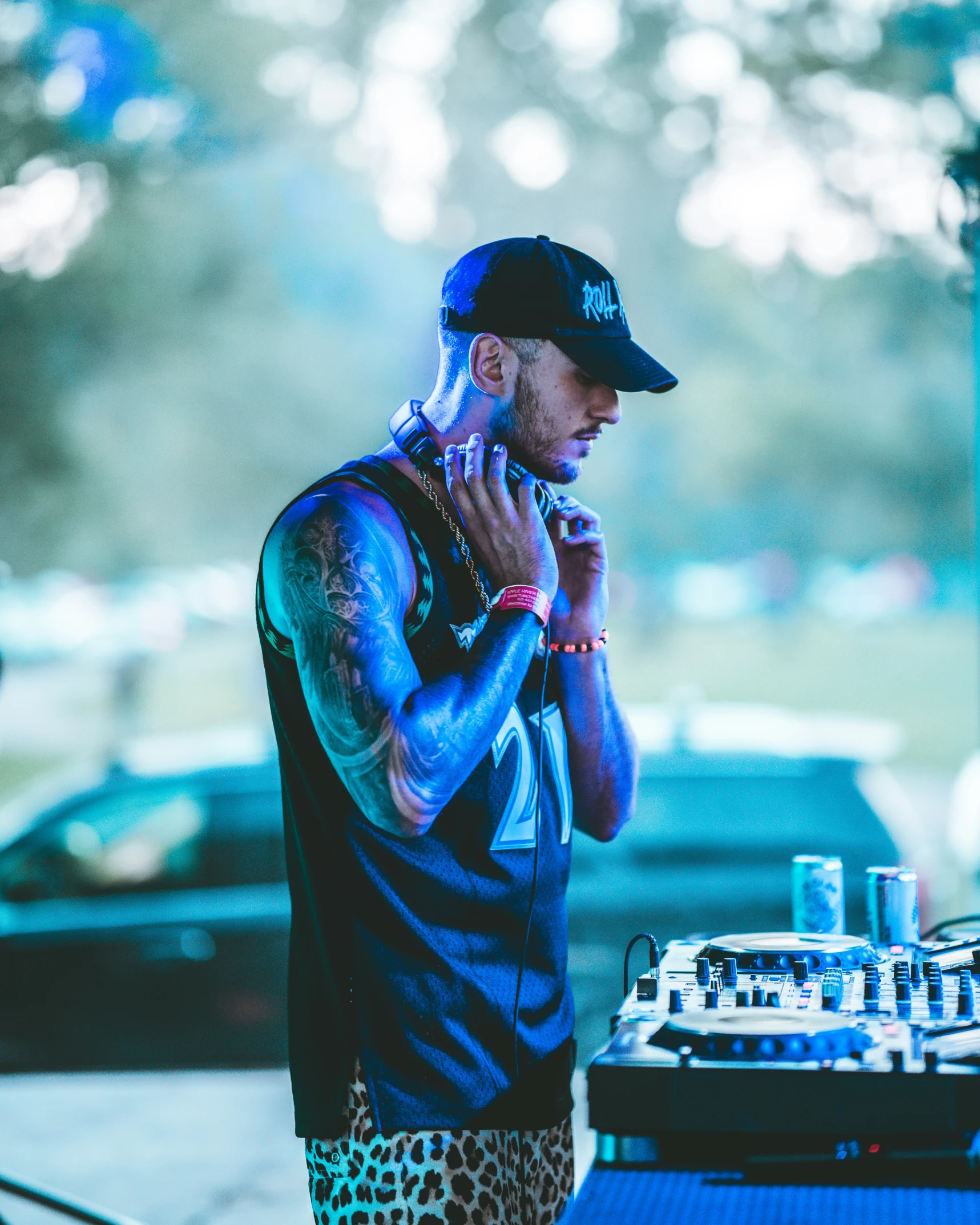 a dj in leopard print shorts plays on his equipment