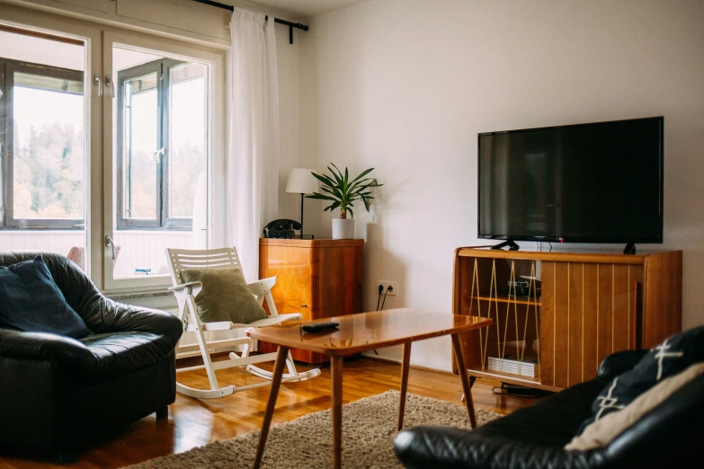 a living room filled with furniture and a flat screen tv