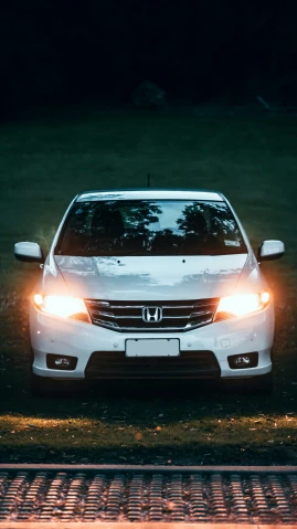 an image of car in the headlights of a white vehicle