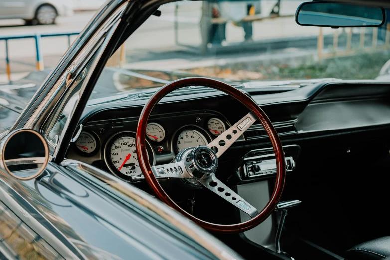 a close up of an old fashioned car dashboard and steering wheel