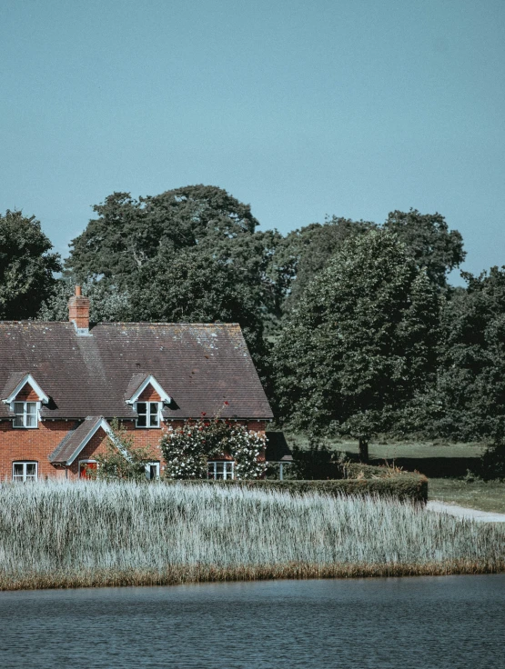 an old brick building with trees near it