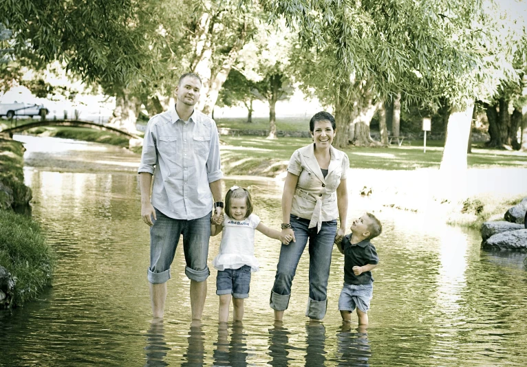 a group of people are standing in a water way