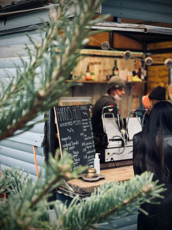 a man and a woman are working behind the counter of a small restaurant