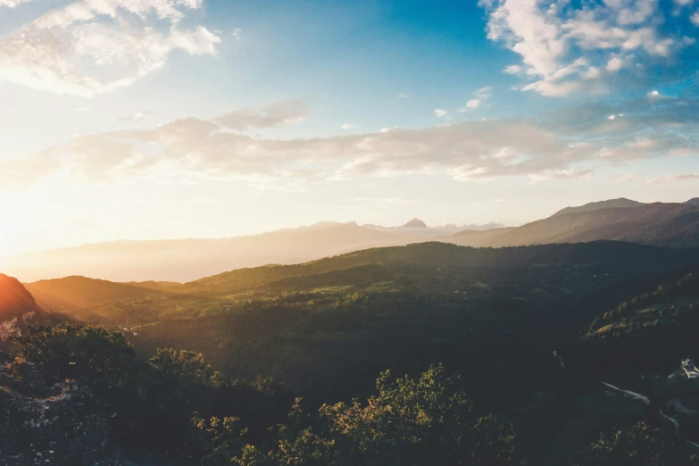 sunset at the top of a mountain with a blue sky above