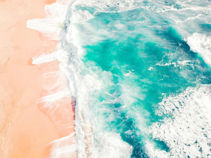 an aerial view of water and beach in the ocean