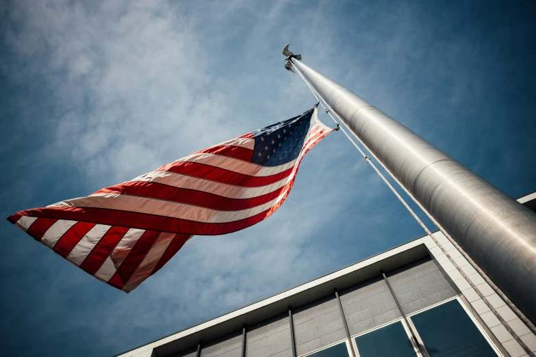 an american flag is waving at high altitude