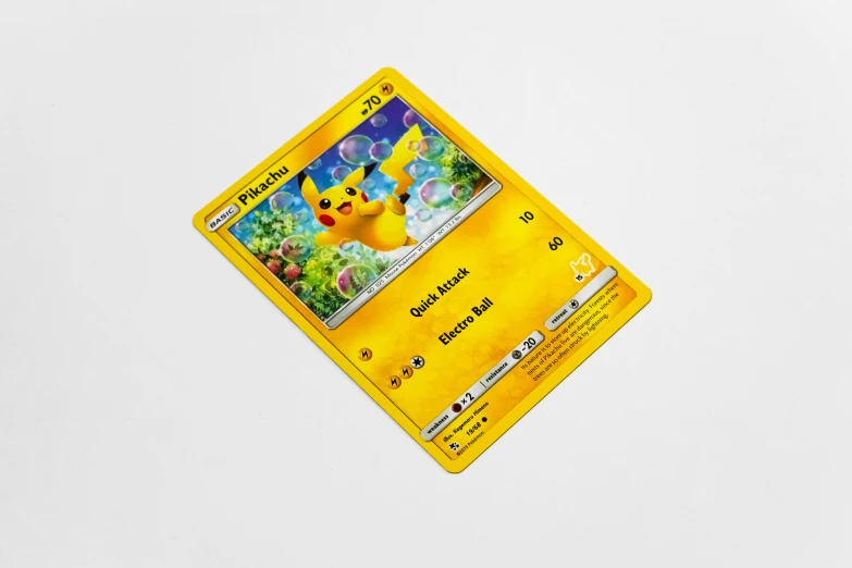 a yellow pokemon card sitting on top of a white counter