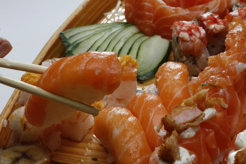 this is sushi on a plate with mushrooms, celery, cucumber and lettuce