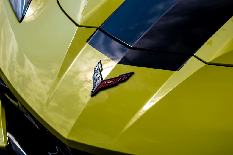 a bright yellow sports car with the logo of corvette on it