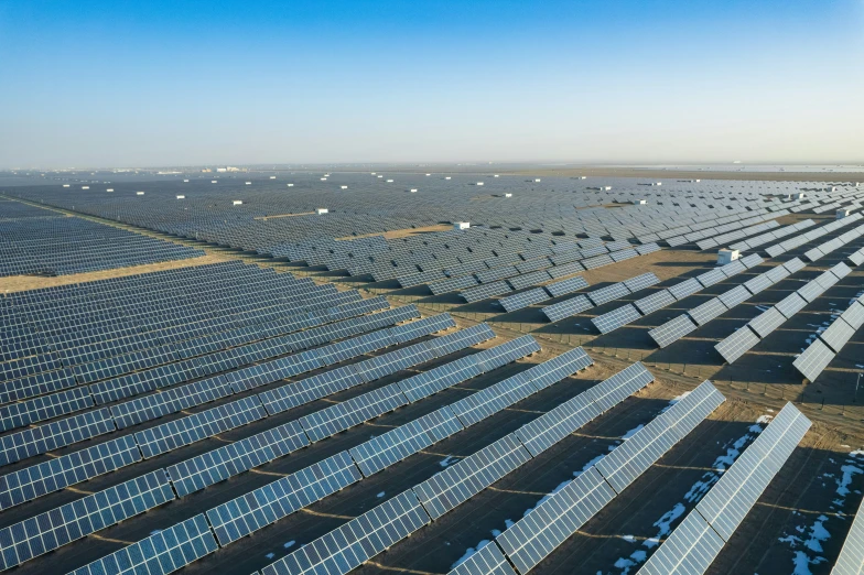 a large group of solar panels next to each other