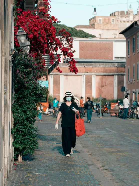 a woman walking in the street carrying some food