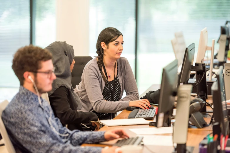 people working on computer in a computer lab