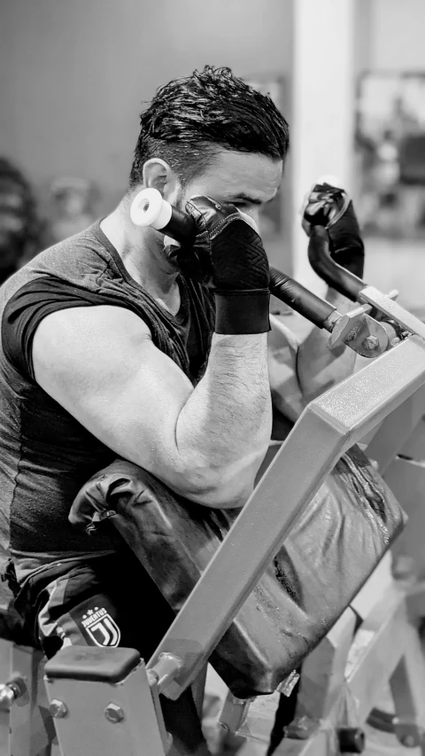 a man sitting on top of a bench in a gym