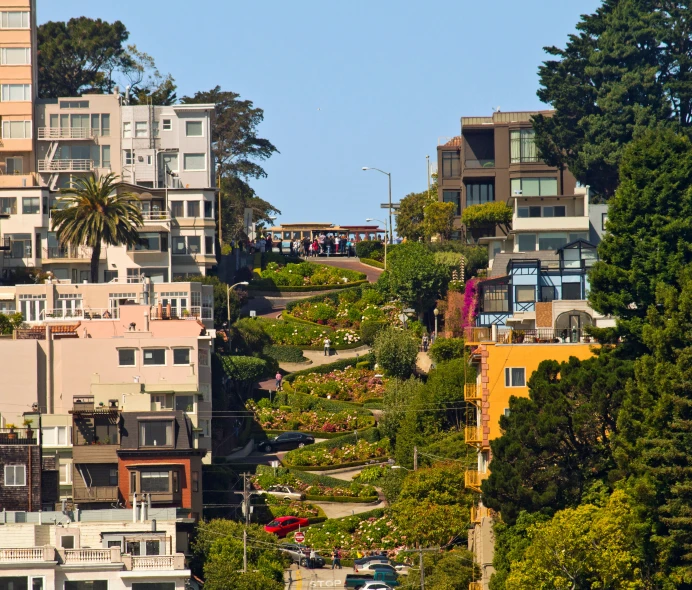 a row of multi - story houses rise from a hillside