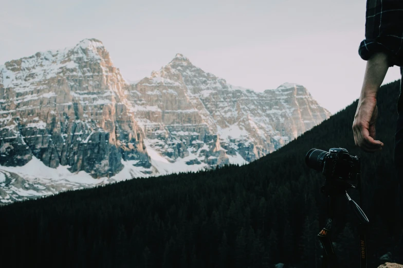 a person on a bike with a snowy mountain in the background