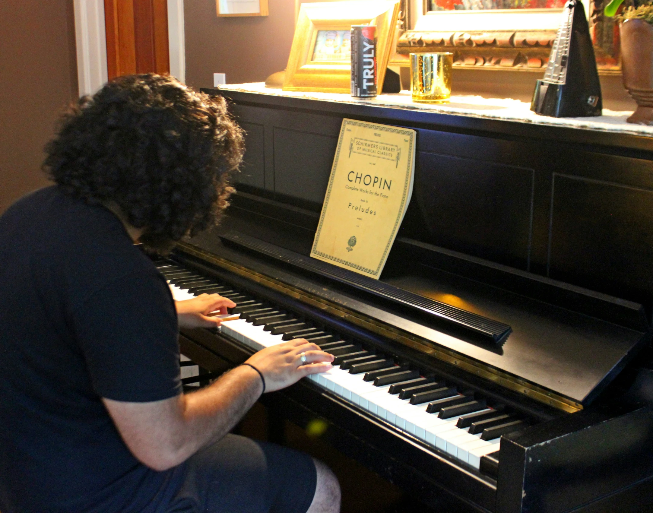 a woman is playing a piano on the side of a room