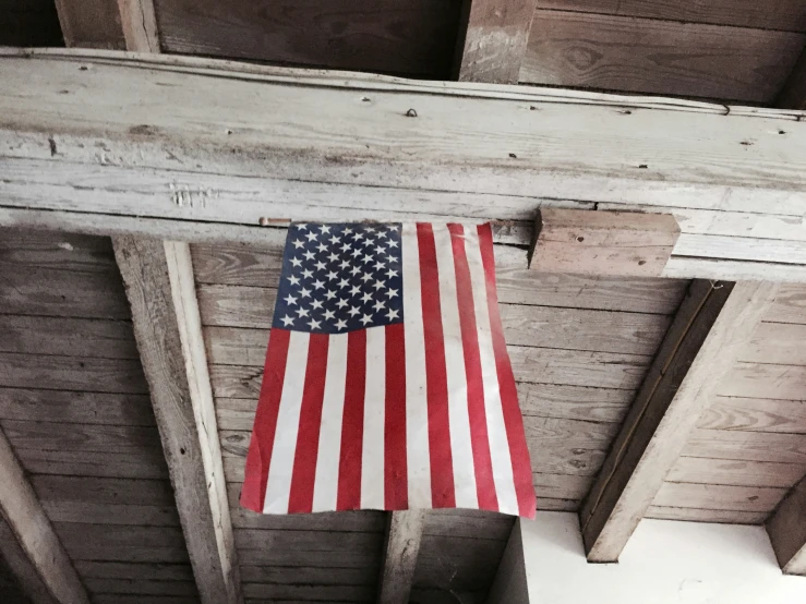 an american flag hanging from the ceiling of a cabin