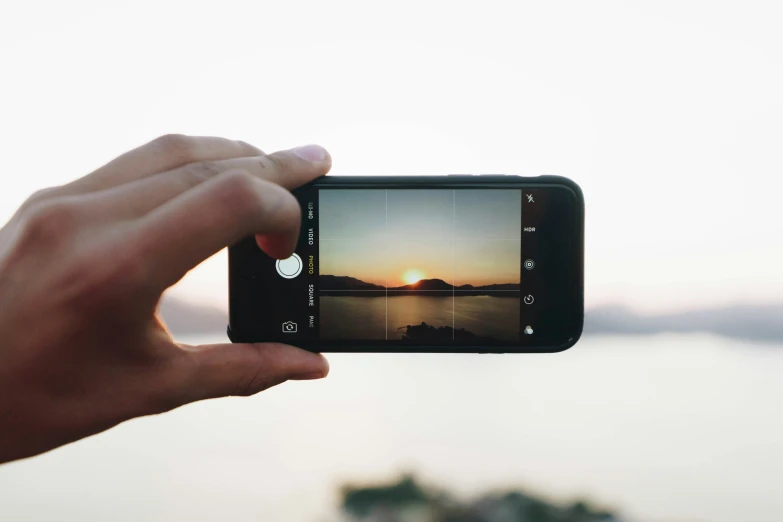 someone holding a phone taking a picture in front of them