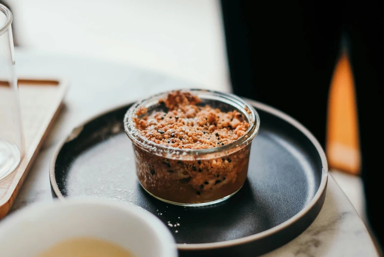 a glass bowl of food on a plate