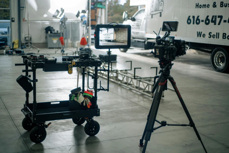 a video camera is next to a trailer and truck