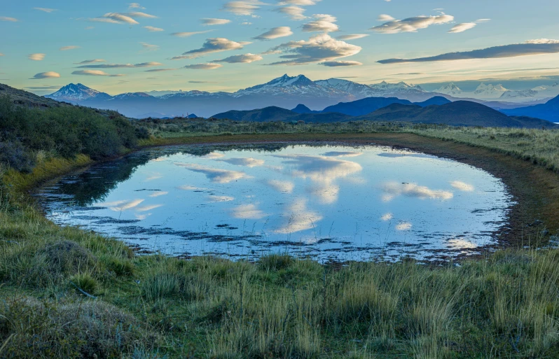 the mountains have snow - capped tops, and water is almost empty