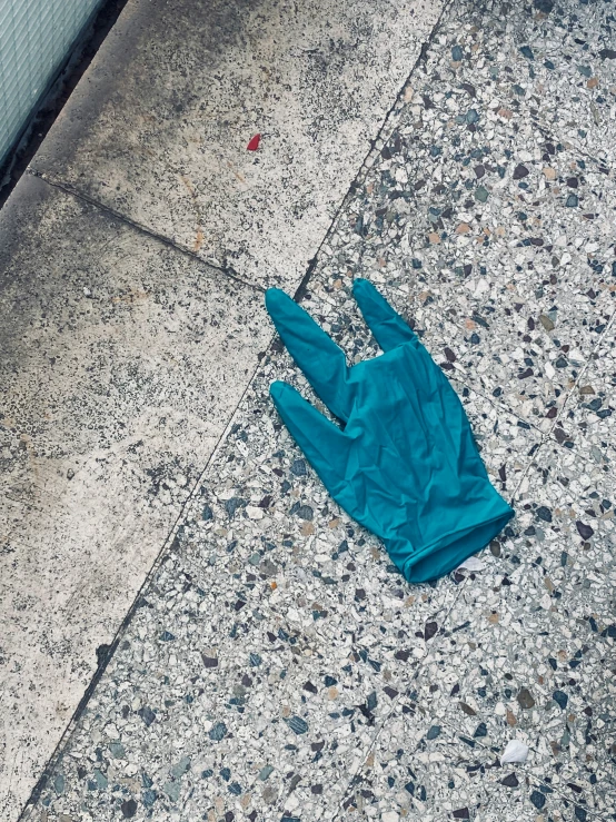 a glove on the ground near a wall